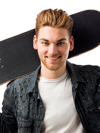Studio portrait of a young man posing with a skateboard Stock Photo - Budget Royalty-Free & Subscription, Code: 400-08074620