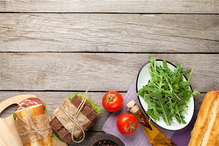 simsearch:400-07099478,k - Two sandwiches with salad, ham, cheese and tomatoes, salad and spices on wooden table. Top view with copy space Stock Photo - Budget Royalty-Free & Subscription, Code: 400-08074761