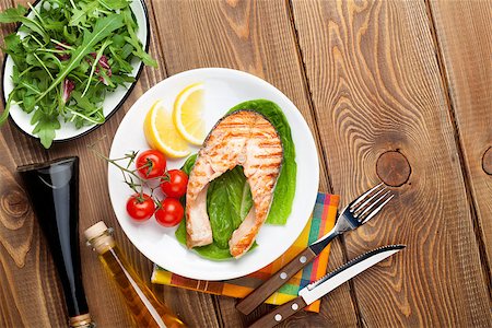 simsearch:400-05295567,k - Grilled salmon, salad and condiments on wooden table. Top view with copy space Stock Photo - Budget Royalty-Free & Subscription, Code: 400-08074772