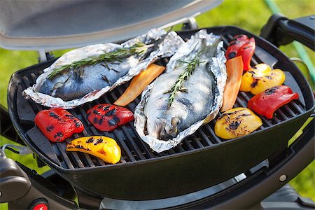 Fresh dorado fish and bell pepper grill cooking outdoors Stock Photo - Budget Royalty-Free & Subscription, Code: 400-08074788