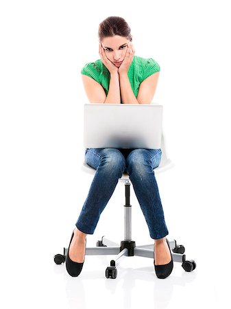 Female student sitting on a chair with a laptop and upset with something, isolated over a white background Stock Photo - Budget Royalty-Free & Subscription, Code: 400-08075060