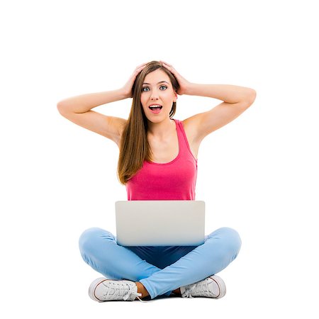 surprised adult work casual - Beautiful woman sitting with crossed legs working with a laptop Stock Photo - Budget Royalty-Free & Subscription, Code: 400-08075092