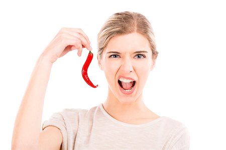 simsearch:400-04575822,k - Beautiful girl making a silly face and holding a red chilli pepper, isolated over a white background Photographie de stock - Aubaine LD & Abonnement, Code: 400-08075256