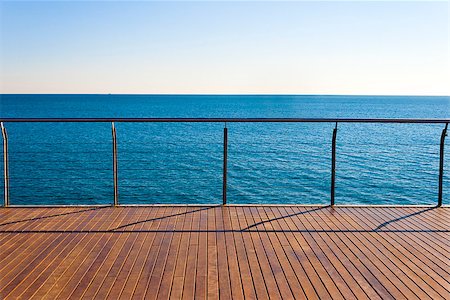 photojope (artist) - Empty ocean viewpoint plattform with wooden floor desk. Clear sky and blue sea in a sunny day of summer. Horizontal composition. Fotografie stock - Microstock e Abbonamento, Codice: 400-08075411