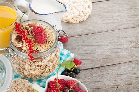 porridge and berries - Healthy breakfast with muesli, berries, orange juice and milk. On wooden table Stock Photo - Budget Royalty-Free & Subscription, Code: 400-08075433