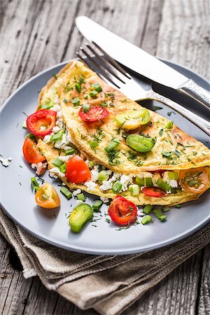 Omelette with vegetables and herbs on a plate Stock Photo - Budget Royalty-Free & Subscription, Code: 400-08075497