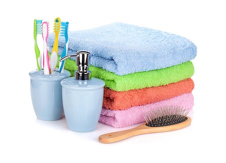 simsearch:6108-05857134,k - Four toothbrushes, liquid soap, hairbrush and colorful towels. Isolated on white background Stock Photo - Budget Royalty-Free & Subscription, Code: 400-08075671