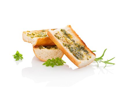 pane all'aglio - Garlic baguette isolated on white background with fesh herbs. Culinary baguette eating. Fotografie stock - Microstock e Abbonamento, Codice: 400-08075946