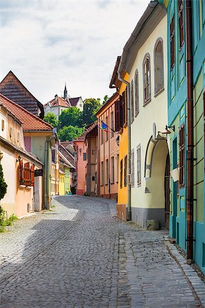 sighisoara - Sighisoara, Romania - June 23, 2013: Stone paved old street with colored houses from Sighisoara fortresss, Transylvania, Romania Photographie de stock - Aubaine LD & Abonnement, Code: 400-08076118