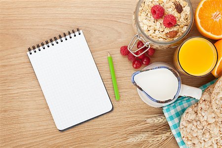 simsearch:400-08113690,k - Healty breakfast with muesli, berries and orange juice. View from above on wooden table with notepad for copy space Stock Photo - Budget Royalty-Free & Subscription, Code: 400-08076136