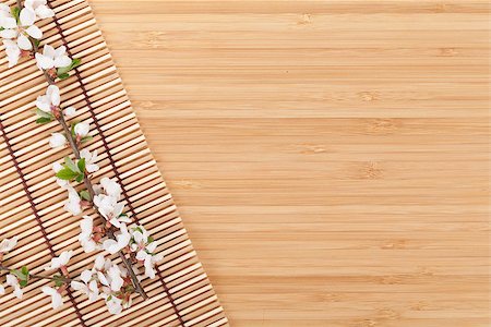 simsearch:400-04576608,k - Sakura branch over bamboo mat with copy space Stock Photo - Budget Royalty-Free & Subscription, Code: 400-08076158