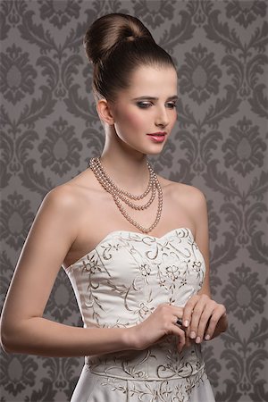 simsearch:400-07822212,k - lovely brunette with elegant hair-style and dress, stylish make-up and pearls jewellery Fotografie stock - Microstock e Abbonamento, Codice: 400-08076191