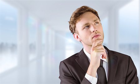 simsearch:400-08076534,k - Young businessman thinking with hand on chin against bright white hall with windows Foto de stock - Royalty-Free Super Valor e Assinatura, Número: 400-08076379