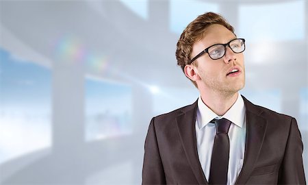 simsearch:400-08076534,k - Young businessman thinking and looking up against bright white room with windows Foto de stock - Royalty-Free Super Valor e Assinatura, Número: 400-08076380