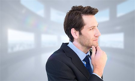 simsearch:400-08076534,k - Thinking businessman touching his chin against bright white room with windows Foto de stock - Royalty-Free Super Valor e Assinatura, Número: 400-08076403