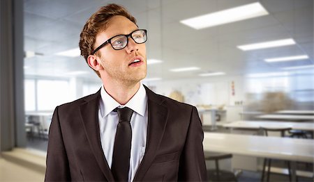 simsearch:700-02121517,k - Young businessman thinking and looking up against empty class room Stock Photo - Budget Royalty-Free & Subscription, Code: 400-08076423