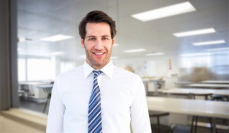 simsearch:700-02121517,k - Smiling businessman standing with hands in pockets against empty class room Stock Photo - Budget Royalty-Free & Subscription, Code: 400-08076432