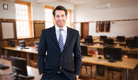 Smiling businessman standing with hands in pockets against computer room Stock Photo - Budget Royalty-Free & Subscription, Code: 400-08076433