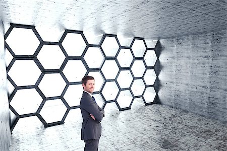 simsearch:400-07186359,k - Businessman standing with arms crossed against hexagon room Photographie de stock - Aubaine LD & Abonnement, Code: 400-08076483