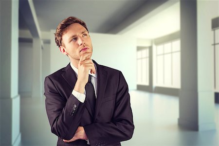 simsearch:400-08020381,k - Young businessman thinking with hand on chin against white room with screen Fotografie stock - Microstock e Abbonamento, Codice: 400-08076536