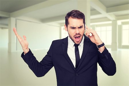 Angry businessman gesturing on the phone against white room with windows Stock Photo - Budget Royalty-Free & Subscription, Code: 400-08076565