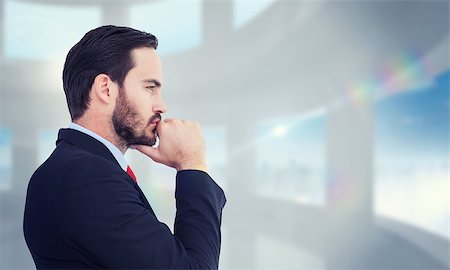 simsearch:400-08076534,k - Thinking businessman standing with hand on chin against bright white room with windows Foto de stock - Royalty-Free Super Valor e Assinatura, Número: 400-08076597