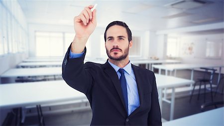 simsearch:700-02121517,k - Businessman holding a chalk and writing something against empty class room Stock Photo - Budget Royalty-Free & Subscription, Code: 400-08076627
