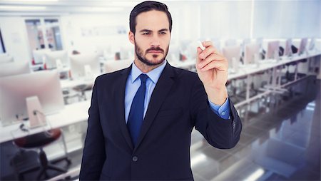 Businessman holding a chalk and writing something against empty computer room Stock Photo - Budget Royalty-Free & Subscription, Code: 400-08076628