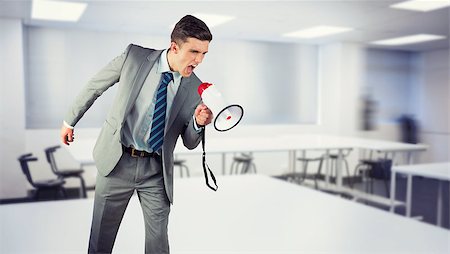 Businessman shouting through megaphone against empty class room Stock Photo - Budget Royalty-Free & Subscription, Code: 400-08076657