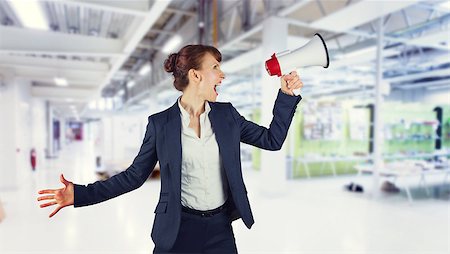 Businesswoman with loudspeaker against classroom Stock Photo - Budget Royalty-Free & Subscription, Code: 400-08076661