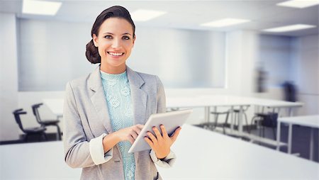 simsearch:700-02121517,k - Brunette using tablet pc against empty class room Stock Photo - Budget Royalty-Free & Subscription, Code: 400-08076674
