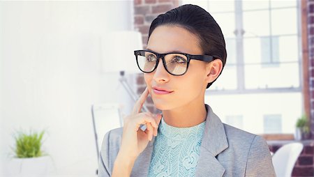 simsearch:400-08076534,k - Happy brunette against laptop on desk with glasses and notepad Foto de stock - Royalty-Free Super Valor e Assinatura, Número: 400-08076670