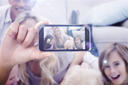 pic of boys in hand mobile - Hand holding smartphone showing against laughting family with their pet yellow labrador on the rug Stock Photo - Budget Royalty-Free & Subscription, Code: 400-08076837