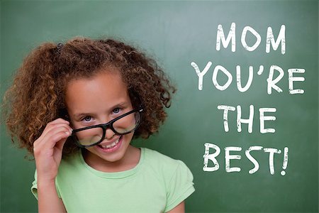 Cute pupil tilting glasses against green chalkboard Stock Photo - Budget Royalty-Free & Subscription, Code: 400-08076877