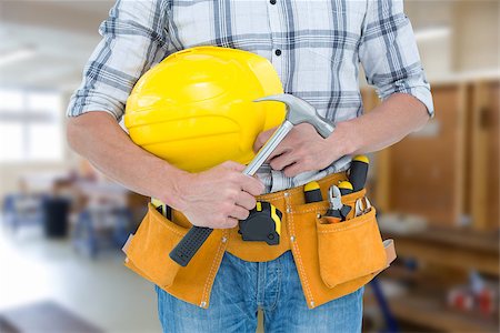 simsearch:400-08077010,k - Technician holding hammer and hard hat against workshop Foto de stock - Super Valor sin royalties y Suscripción, Código: 400-08076997