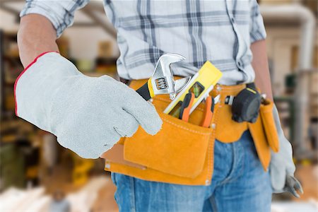 simsearch:400-08077074,k - Technician using adjustable wrench against white background against workshop Foto de stock - Super Valor sin royalties y Suscripción, Código: 400-08077037