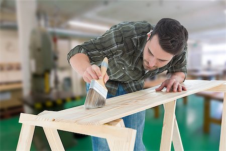 simsearch:400-08077046,k - Worker using brush on wooden plank against workshop Foto de stock - Super Valor sin royalties y Suscripción, Código: 400-08077046