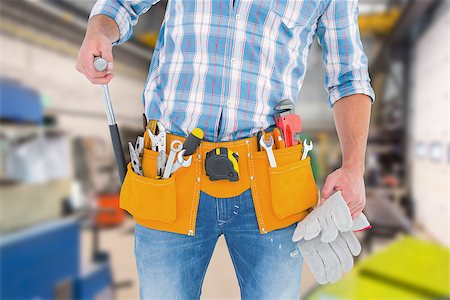 simsearch:400-08077074,k - Midsection of handyman holding hammer and gloves against workshop Foto de stock - Super Valor sin royalties y Suscripción, Código: 400-08077061