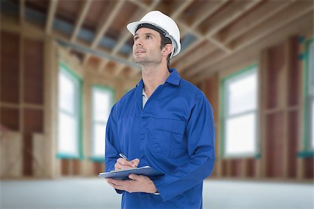 Supervisor writing notes on clip board against house under construction Photographie de stock - Aubaine LD & Abonnement, Code: 400-08077084