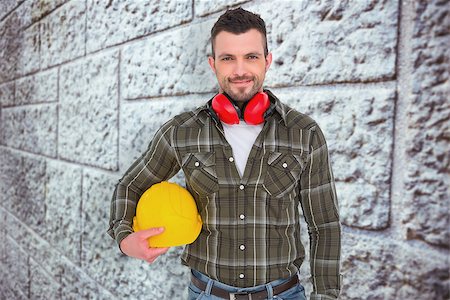 simsearch:400-08077074,k - Handyman with earmuffs holding helmet  against grey brick wall Foto de stock - Super Valor sin royalties y Suscripción, Código: 400-08077140