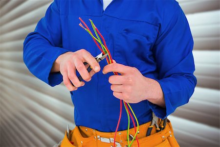 Electrician cutting wire with pliers against grey shutters Stock Photo - Budget Royalty-Free & Subscription, Code: 400-08077142