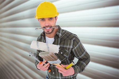 simsearch:400-08077074,k - Manual worker holding various tools against grey shutters Foto de stock - Super Valor sin royalties y Suscripción, Código: 400-08077159