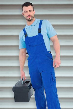 Repairman with toolbox  against grey shutters Stock Photo - Budget Royalty-Free & Subscription, Code: 400-08077186