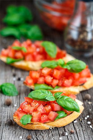 sandwich rustic table - Tomato bruschetta with chopped tomatoes and basil on toasted bread Stock Photo - Budget Royalty-Free & Subscription, Code: 400-08077539