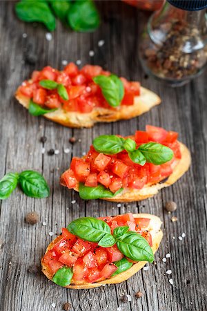 sandwich rustic table - Tomato bruschetta with chopped tomatoes and basil on toasted bread Stock Photo - Budget Royalty-Free & Subscription, Code: 400-08077540
