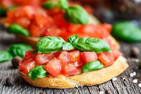 sandwich rustic table - Tomato bruschetta with chopped tomatoes and basil on toasted bread Stock Photo - Budget Royalty-Free & Subscription, Code: 400-08077541