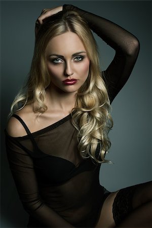 glamour blonde girl with long wavy hair and transparent dark underwear shirt, black bra and sexy stockings. Sitting and looking in camera with charming expression Photographie de stock - Aubaine LD & Abonnement, Code: 400-08077575