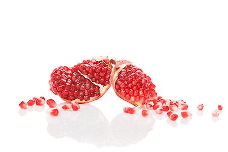 simsearch:640-02656973,k - Pomegranate pieces and core isolated on white background. Healthy fruit eating background, contemporary minimal sparse style. Fotografie stock - Microstock e Abbonamento, Codice: 400-08077726