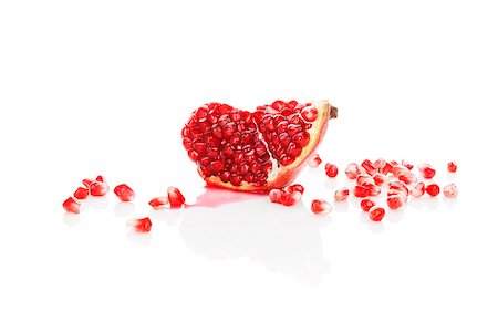 simsearch:640-02656973,k - Pomegranate isolated on white background. Healthy fruit eating. Fotografie stock - Microstock e Abbonamento, Codice: 400-08077728