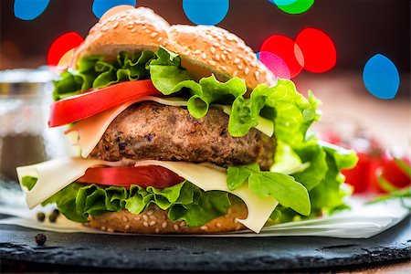 pub burger - Closeup of Homemade Hamburger with Fresh Vegetables and Lights in Background Stock Photo - Budget Royalty-Free & Subscription, Code: 400-08078070